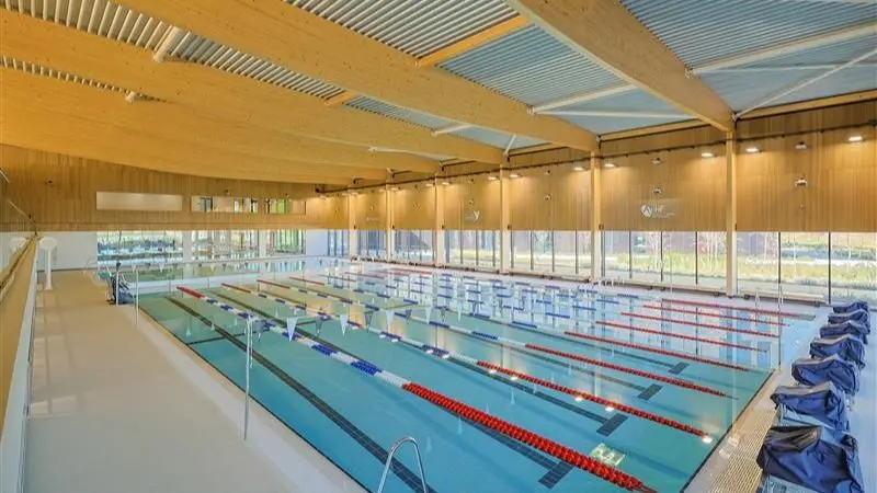 Eight-lane swimming pool with lane ropes at Canolfan Pentre Awel.