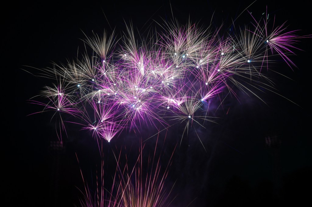 Fireworks streaking across the night sky with trails of colour above Swansea.