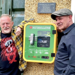 Shaun Greaney, Lliedi councillor and defibrillator campaigner, pictured with his brother Ian next to a publicly accessible defibrillator in Hedley Terrace, Llanelli.