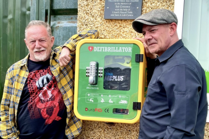 Shaun Greaney, Lliedi councillor and defibrillator campaigner, pictured with his brother Ian next to a publicly accessible defibrillator in Hedley Terrace, Llanelli.