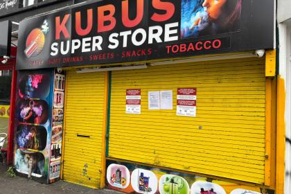 Kubus Vapes in Swansea closed by Trading Standards, with shutters down and closure notices attached following a crackdown on illegal vapes and tobacco.