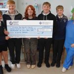 Meinir Morgan with sons Iestyn, Lewis, Rhys and Ioan handing over a cheque to staff at Singleton Hospital’s Chemotherapy Day Unit.