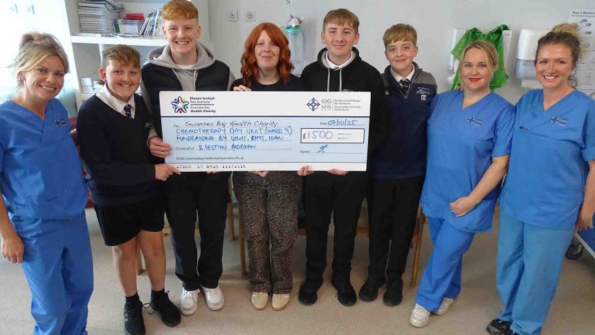 Meinir Morgan with sons Iestyn, Lewis, Rhys and Ioan handing over a cheque to staff at Singleton Hospital’s Chemotherapy Day Unit.