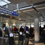 Passport control desks inside Munich International Airport, Terminal 1, with barriers and booths for arriving passengers.