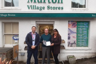 David and Helen Jenkins stand with Post Office Area Manager Ryan Leonard outside Murton Post Office to mark David’s retirement after nearly four decades.