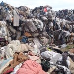 Photo shows huge mounds of baled textile waste illegally deposited at a Caerphilly farm, part of a case that led to a £322,500 repayment order.