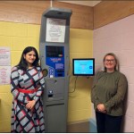 Dr Sowndarya Shivaraj and Lorraine Thomas standing beside a health monitoring machine at Princess Street Surgery, Gorseinon.
