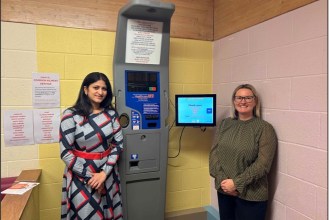 Dr Sowndarya Shivaraj and Lorraine Thomas standing beside a health monitoring machine at Princess Street Surgery, Gorseinon.