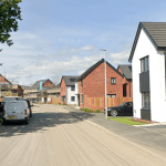 Screenshot of Persimmon’s Garden Village housing development in Swansea, a 700‑home scheme with school and community facilities now under construction.