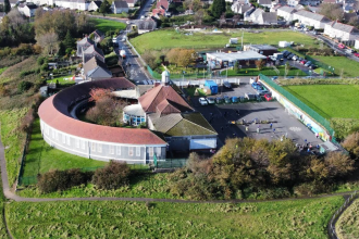 Drone photograph showing Sea View Community Primary School and surrounding Mayhill neighbourhood in Swansea, Wales.