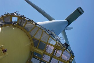 Detailed close‑up of the underside of a large offshore wind turbine, illustrating the scale of renewable energy infrastructure central to Wales’ offshore wind ambitions.