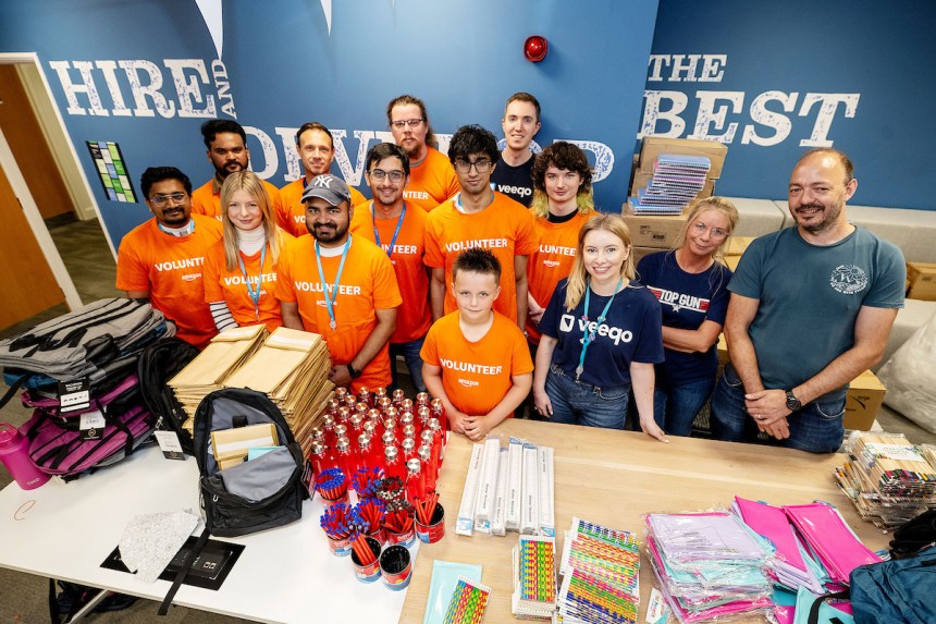 Table of school supplies at Amazon Swansea prepared for packing into 950 backpacks donated to Cwtch Mawr Multibank.