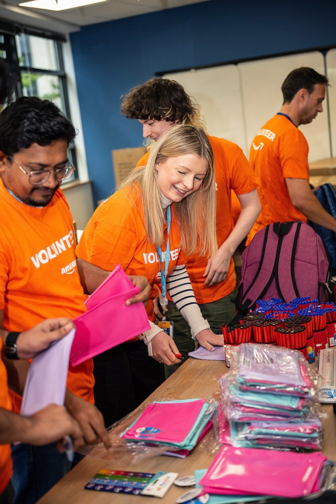 Amazon Swansea employees collaborate to prepare 950 school backpacks for donation through Cwtch Mawr Multibank.