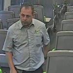 CCTV still of Nicholas McMurray walking through a train carriage.
