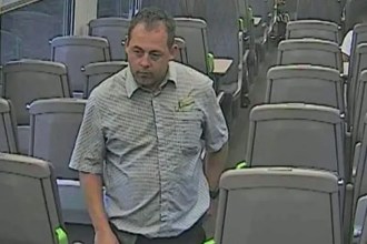 CCTV still of Nicholas McMurray walking through a train carriage.