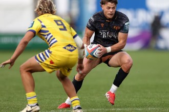 Ospreys full‑back Jack Walsh carries the ball under pressure from Zebre No.9 Thomas Dominguez in the URC match at the Brewery Field, where the Welsh side sealed a 24–0 victory.