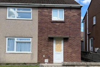 A boarded‑up front door at a house in Pyle where South Wales Police recovered bullets after a reported shooting in September 2025.