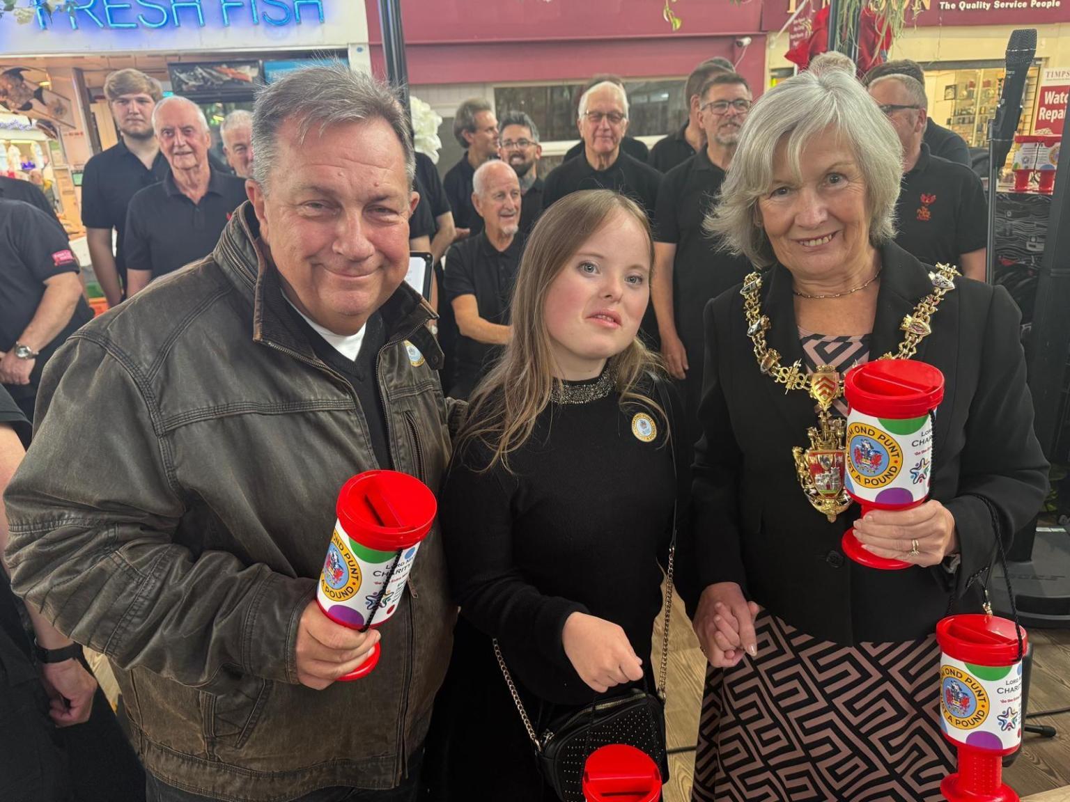 Lord Mayor Cheryl Philpott and Kev Johns launched the Just a Pound appeal at Swansea Market, joined by supporters and the Phoenix Choir of Wales