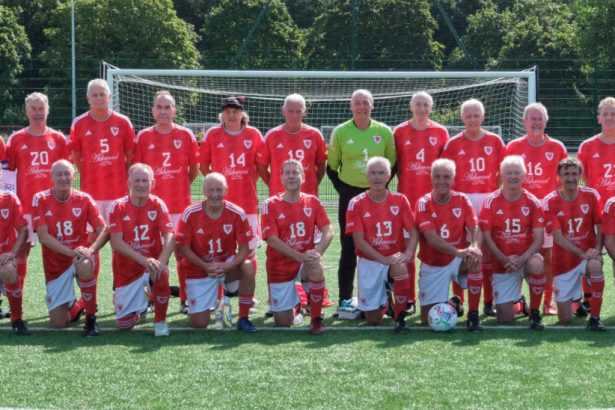 Wales Over‑70s football squad pictured together in Japan, celebrating back‑to‑back World Cup triumphs after defeating England in the final.