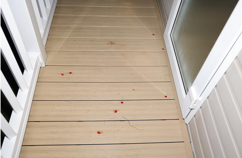 Blood spots visible on the terrace outside a static caravan, photographed by police.