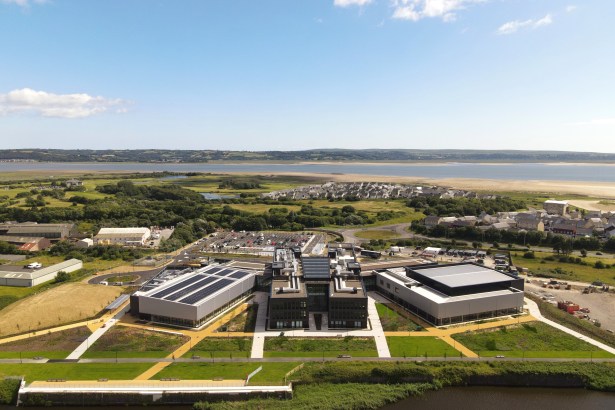 Aerial drone image of Pentre Awel wellness village with Llanelli Bay and Machynys coastline visible behind.