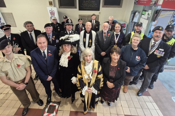 Group photo taken from above showing the Lord Mayor of Swansea in ceremonial robes surrounded by the High Sheriff, council leaders, armed forces representatives, veterans, councillors and police at the Poppy Appeal launch.