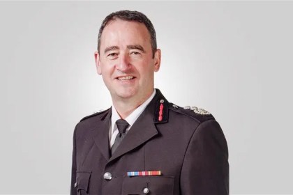 Chief Fire Officer Roger Thomas wearing his fire service uniform.