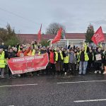 Group of striking First Cymru bus workers standing together on the picket line in South Wales.
