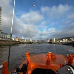 View from an RNLI lifeboat in the River Tawe at SA1, showing a helicopter overhead during the search operation.