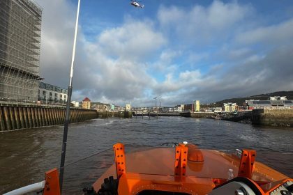 View from an RNLI lifeboat in the River Tawe at SA1, showing a helicopter overhead during the search operation.