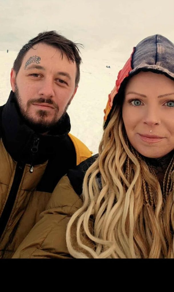Portrait of urban explorers Beth and Robbie standing outdoors in winter clothing, part of their documentation of Swansea’s Elysium Theatre.