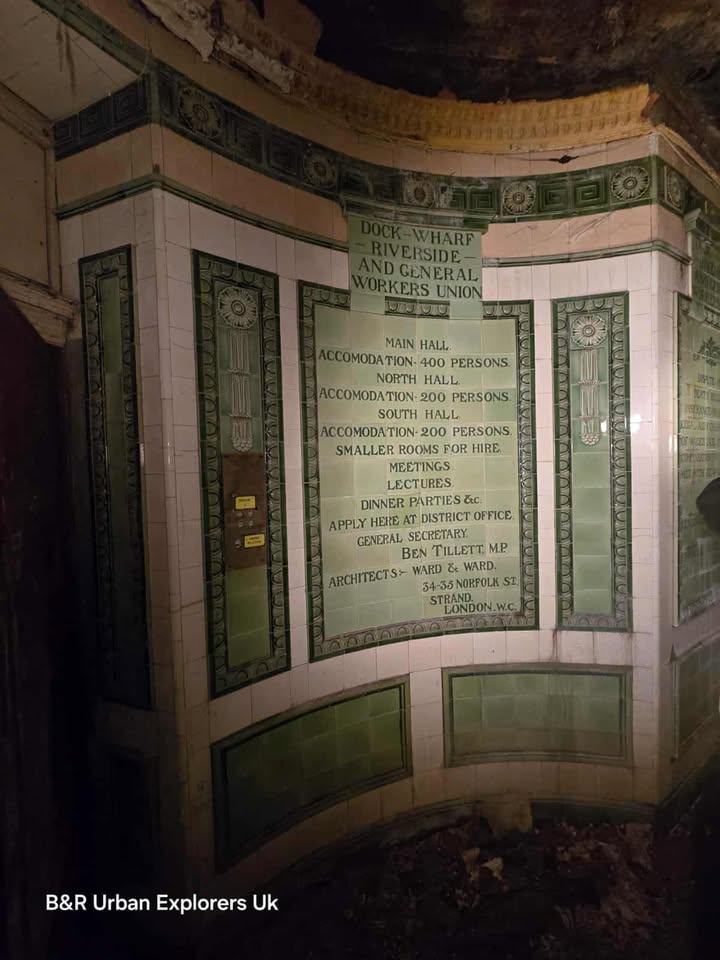 Green and white tiled wall with plaque listing hall capacities and contact info for Dockers’ Union.