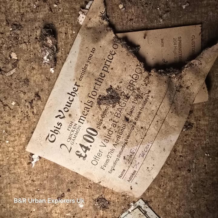 Old voucher offering two meals for £4.00 found on debris-covered surface.
