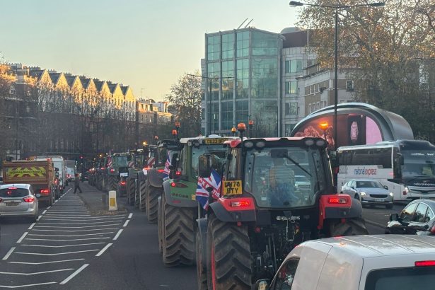 Tractors driving through busy London street during Budget Day protest