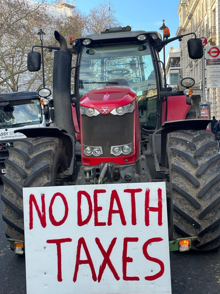 Red tractor with “NO DEATH TAXES” sign outside HM Treasury