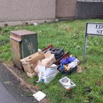 Litter and dumped materials on Edward Street, Port Talbot, including cardboard boxes, clothing and motor oil.
