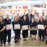 Group photo of Swansea Council, Swim Wales and Freedom Leisure representatives at Penlan Leisure Centre.