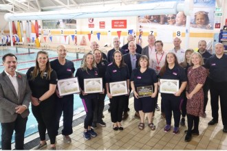Group photo of Swansea Council, Swim Wales and Freedom Leisure representatives at Penlan Leisure Centre.