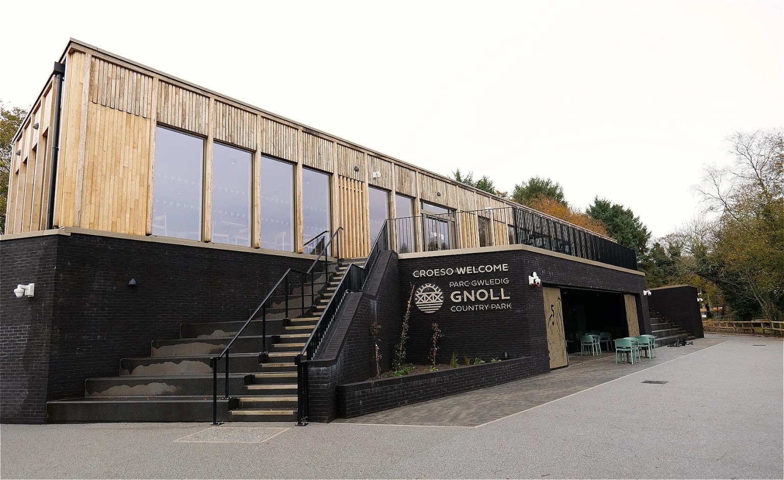 Exterior wide shot of the new Visitor Centre at Gnoll Country Park in Neath, showing modern facilities created during the £12m redevelopment.
