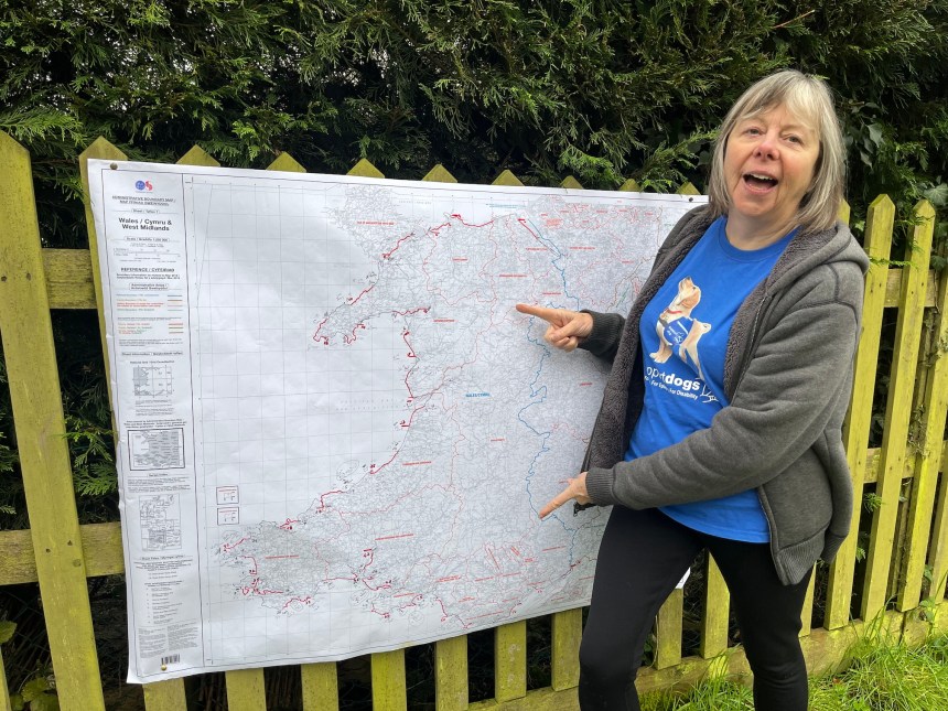 Janet Baldock pointing to a location on a Wales Coast Path map during her charity walk
