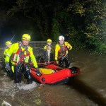 Emergency crews in inflatable boats rescuing dogs from floodwaters at Glanrhyd Dog Sanctuary, Carmarthenshire.