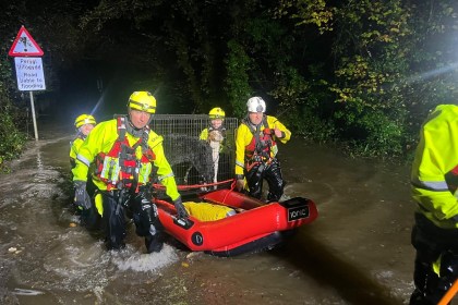 Emergency crews in inflatable boats rescuing dogs from floodwaters at Glanrhyd Dog Sanctuary, Carmarthenshire.