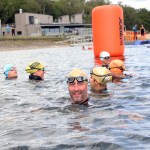 A group of swimmers in Lisvane and Llanishen Reservoir, Cardiff, with clear water and surrounding greenery, reflecting its new ‘excellent’ bathing water status.