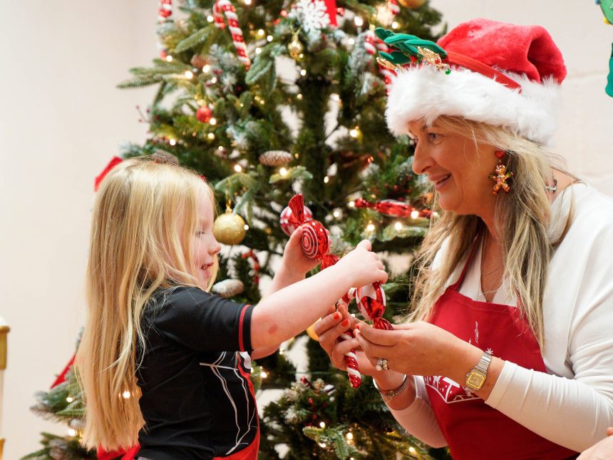 Geraldine Bradley, Carmarthenshire lottery winner, with Kiara, aged 3, wrapping toy gift boxes at ToyBox Project in Caerphilly.