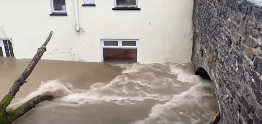 The Cresselly Arms pub in Pontargothi with floodwater reaching halfway up its ground floor windows.