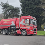 Road sweeper lorry cleaning Cwmbwrla roundabout following flooding.