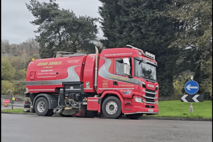 Road sweeper lorry cleaning Cwmbwrla roundabout following flooding.
