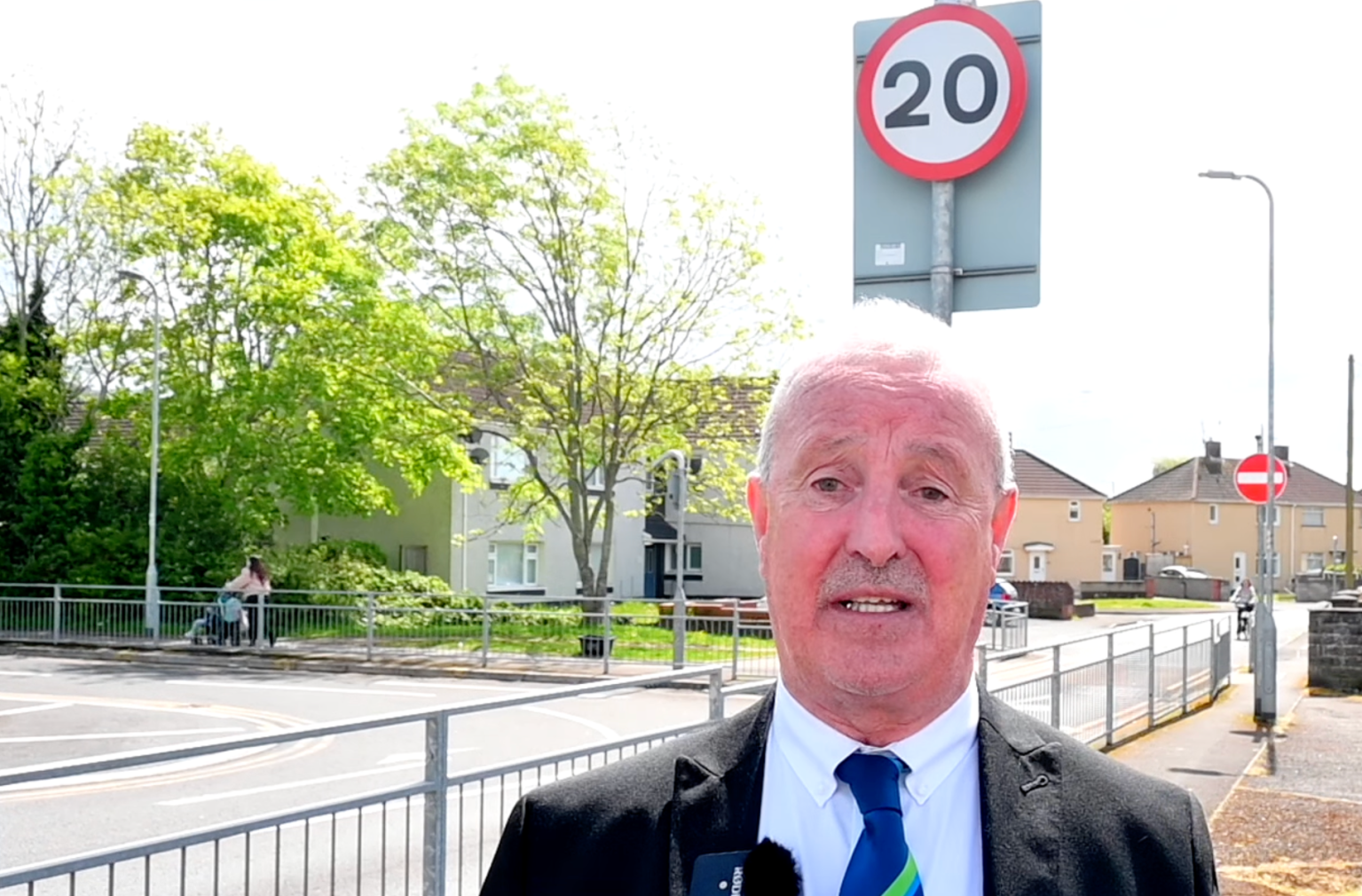Council leader Steve Hunt standing beside a 20mph road sign in Neath Port Talbot.
