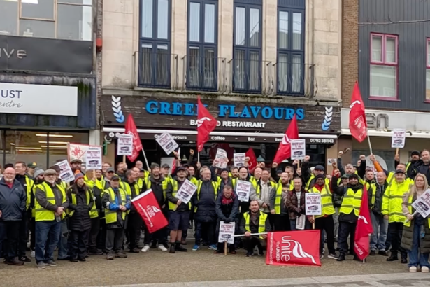 Group of First Cymru bus drivers on strike in Swansea, standing on Kingsway with Unite union banners.