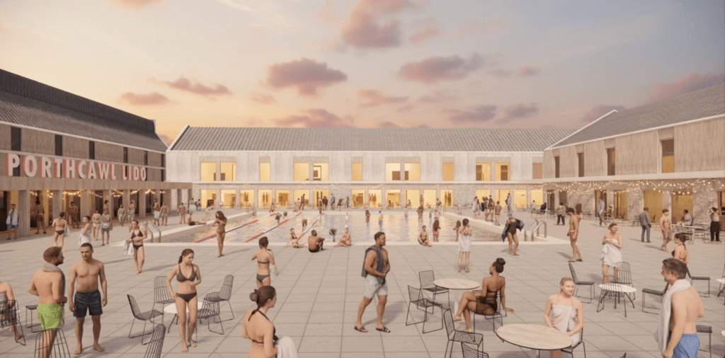 Sunset view of Porthcawl Lido with swimmers and social spaces.